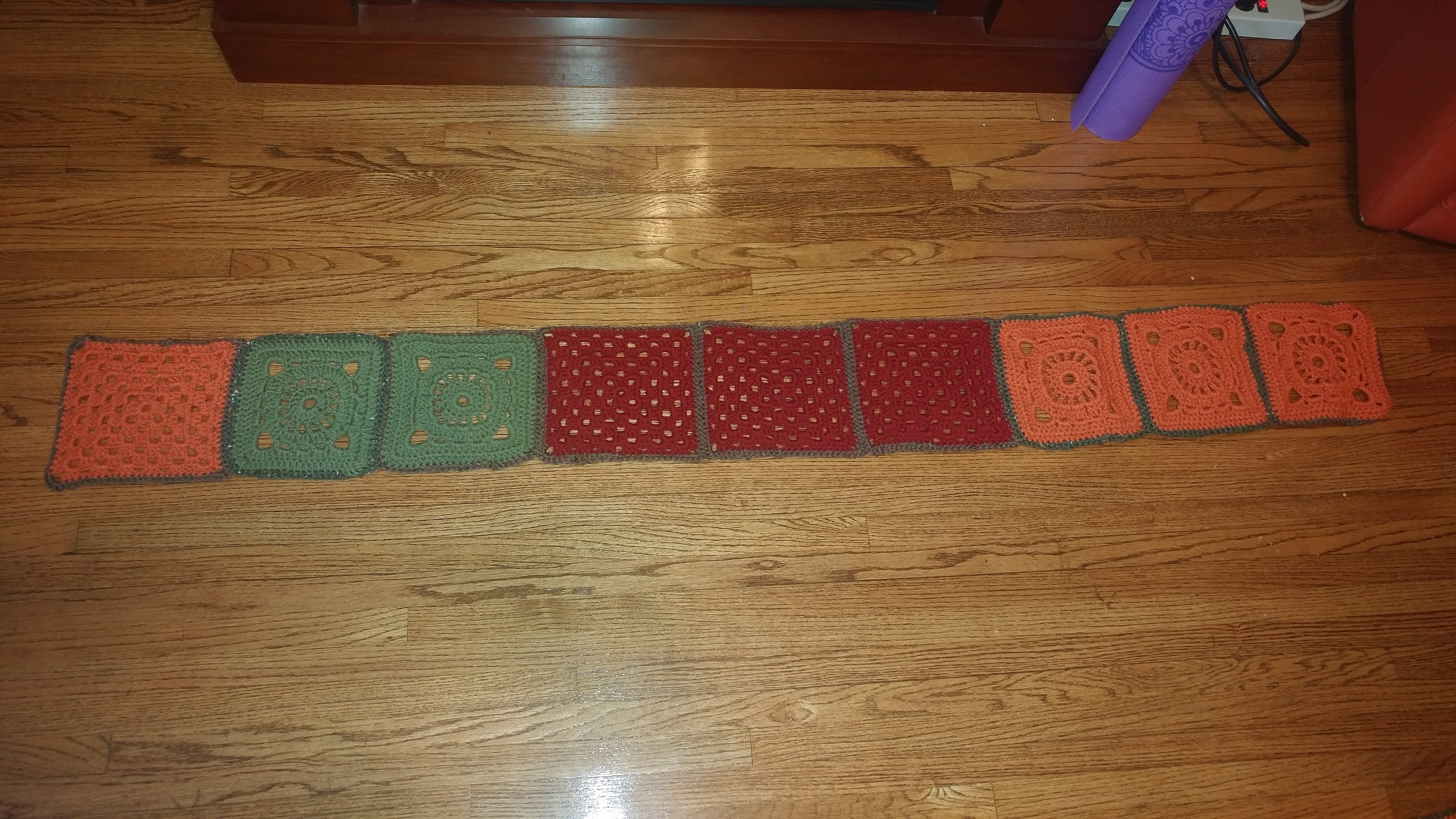 The first nine squares of my blanket, a combination of green, orange, and red.